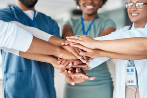 Provider hands stacked in solidarity and support