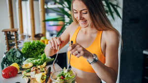 Fit woman making healthy vegetable salad