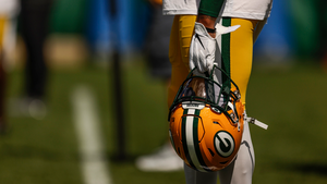 Packers player holding helmet