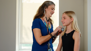 Kim Shefchik, PA-C performs wellness exam on adolescent girl