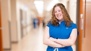 female nurse with arms crossed, smiling
