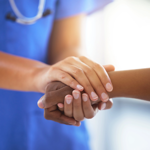 Provider holding patient hand