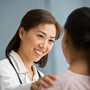 Caring provider talking to female patient
