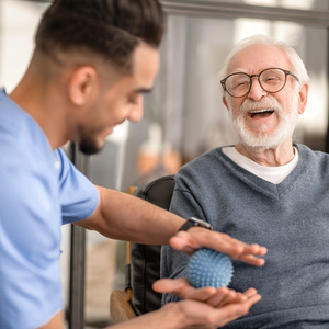 Patient undergoing a session of physical therapy with a massage ball