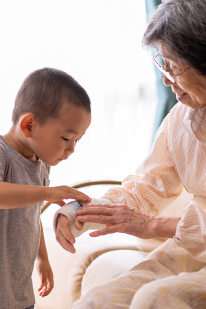 Young boy comforting his grandma's wrist fracture