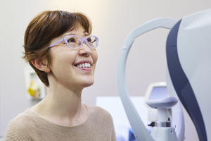 Woman getting her eyesight measured to buy new glasses