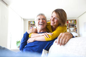 Portrait of laughing couple in the living room