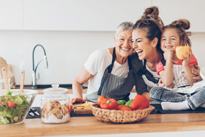 Three generations women laughing in the kitchen